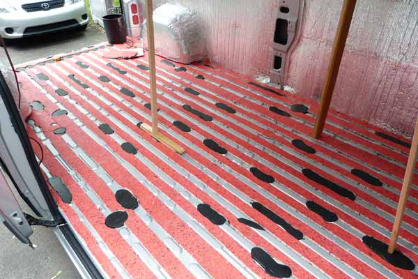 Les bandes de sous-tapis de mousse comblant les
                    rainures du plancher tôlé
